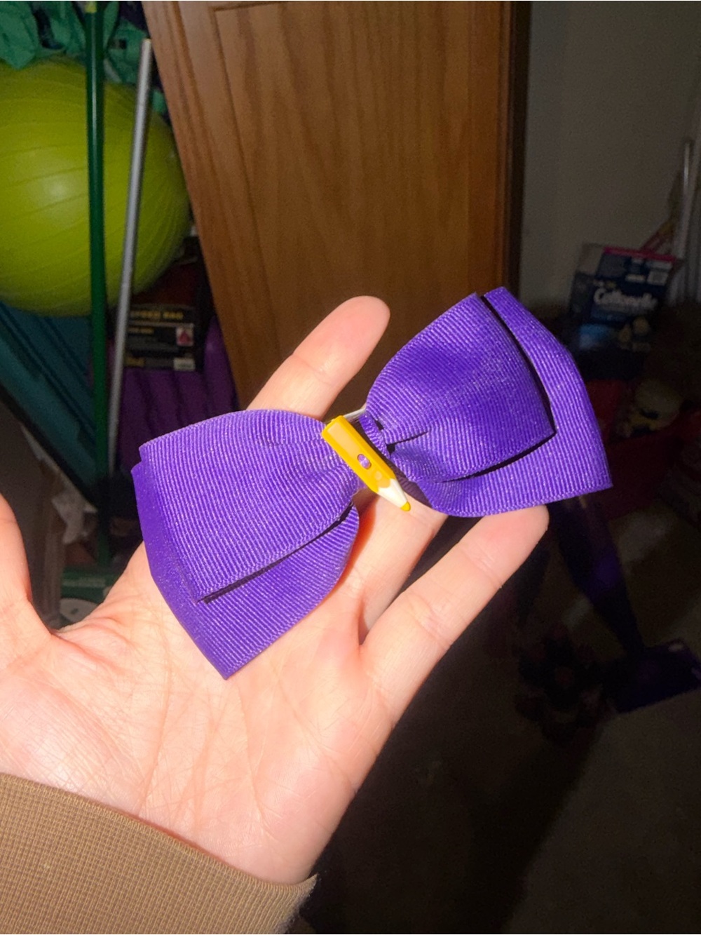 Purple bow hair clip with yellow pencil